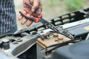 services techniques person holding red and black handle stainless steel fork