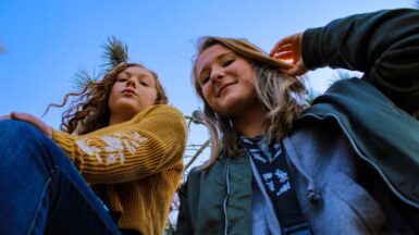 Service jeunesse two women posing and looking down at the camera