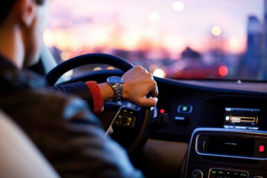 bourse au permis de conduire man driving a car wearing wrist watch