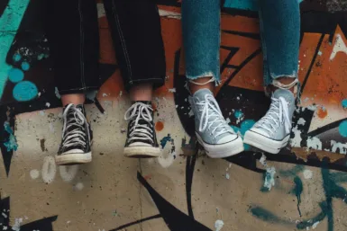 accueil jeunes jeunesse person in blue denim jeans wearing black and white converse all star high top sneakers