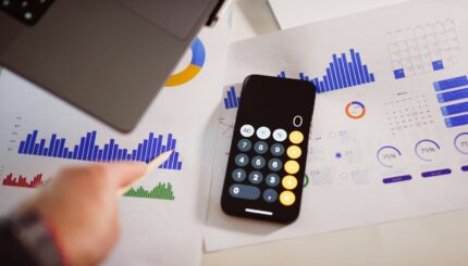 budget a calculator sitting on top of a table next to a laptop