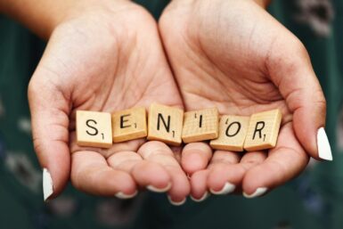 Seniors dice on person's palm