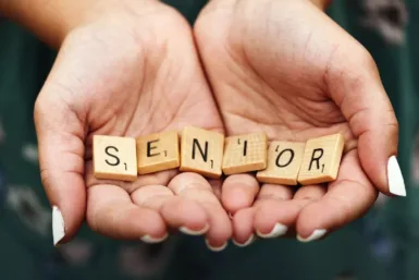 Seniors dice on person's palm