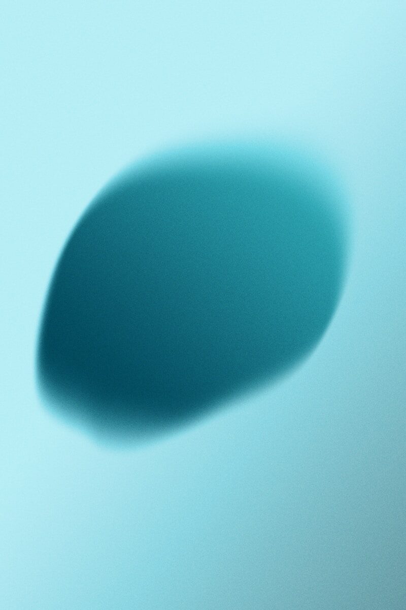 Abstract teal oval shape on light blue background