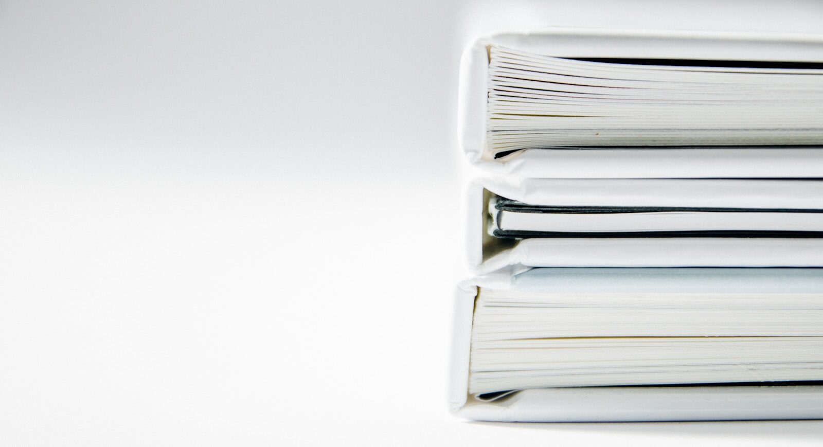 actes administatifs A stack of thick folders on a white surface