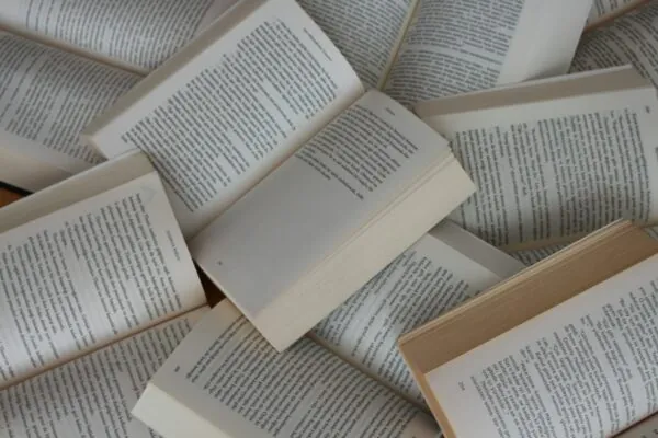 pile of open paperback books