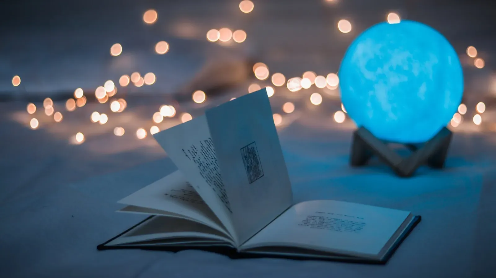 atelier créatif opened book beside crystal ball