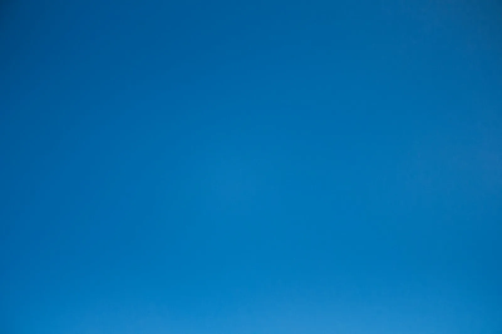 A clear and cloudless bright blue sky